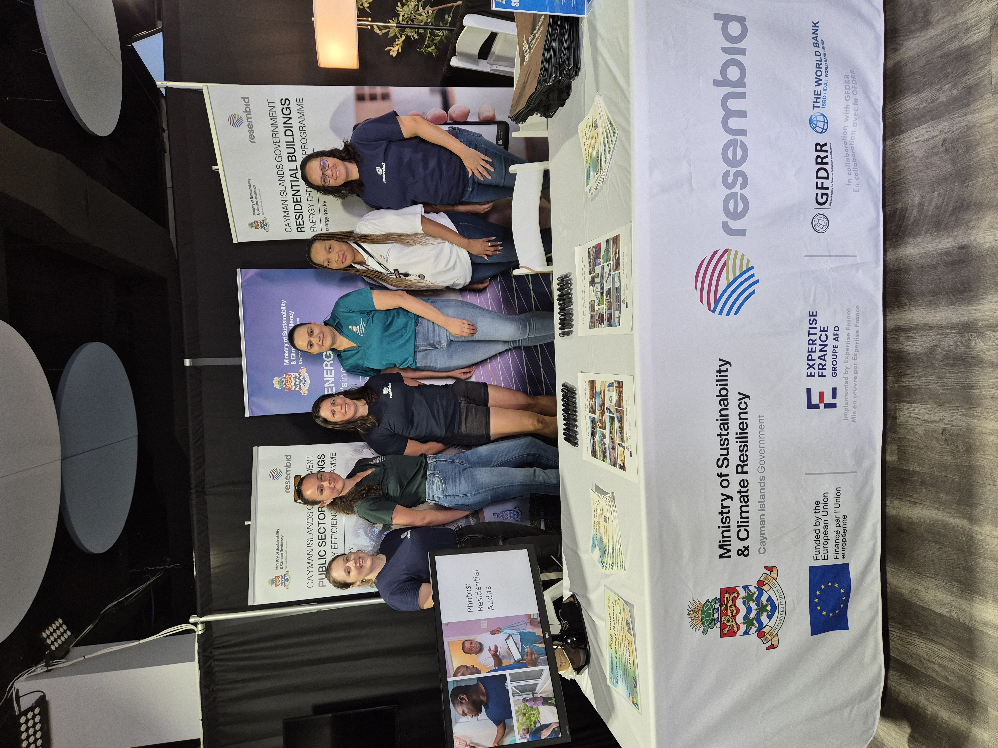 Cayman Islands Civil Servants and Minister pose for a picture infront of their table at the 2024 Builder Expo held in Grand Cayman in collaboration with resembid. 