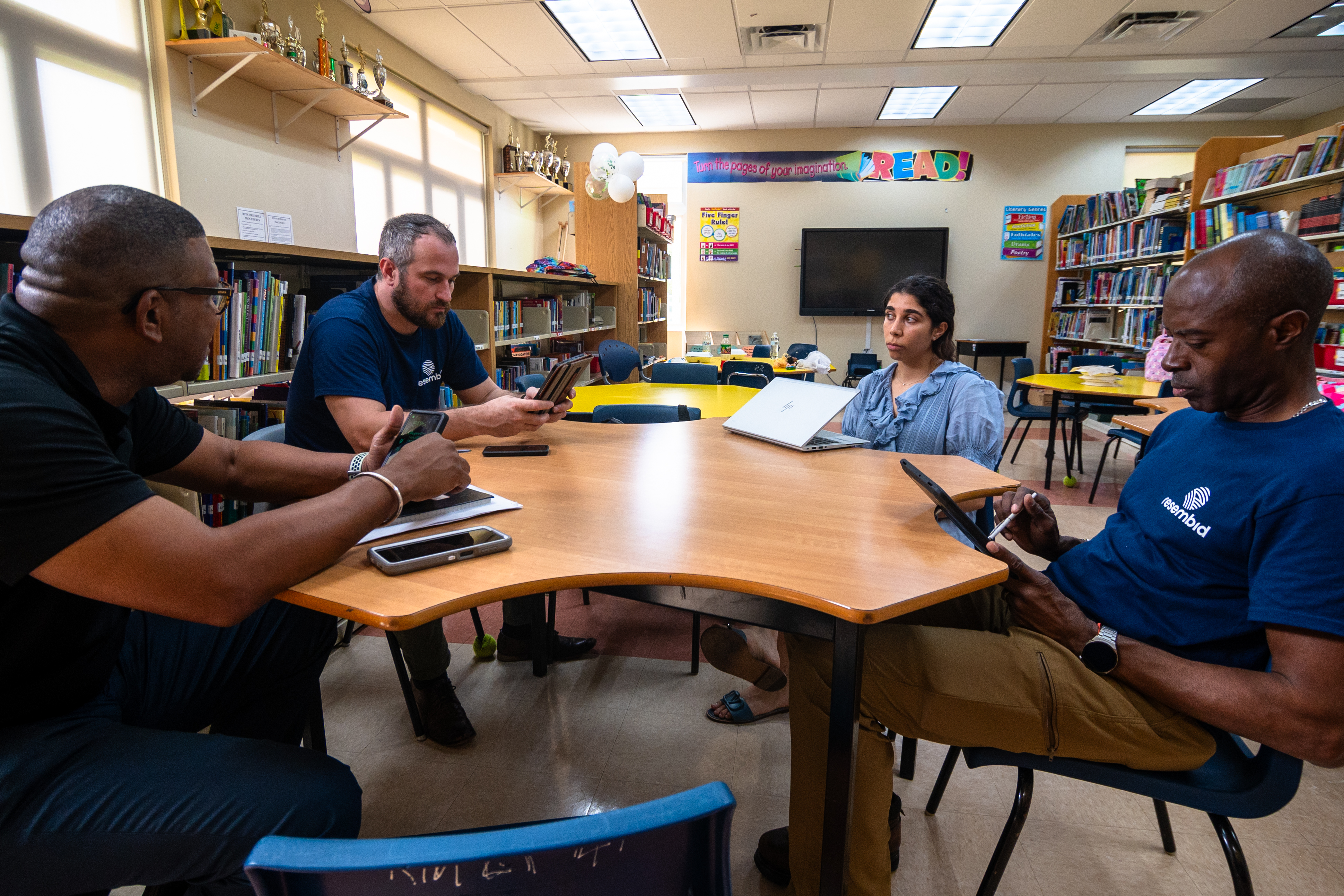 Group of Civil Servants collaborate around a desk on ways to improve energy effiecency after audit. 